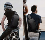 Black anti-theft sling bag made of waterproof Oxford cloth and PU leather worn by man on motorcycle and seated outdoors