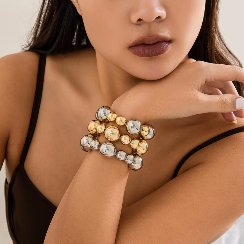 woman wearing goth vintage big CCB chain bracelets in gold and silver colors on wrist