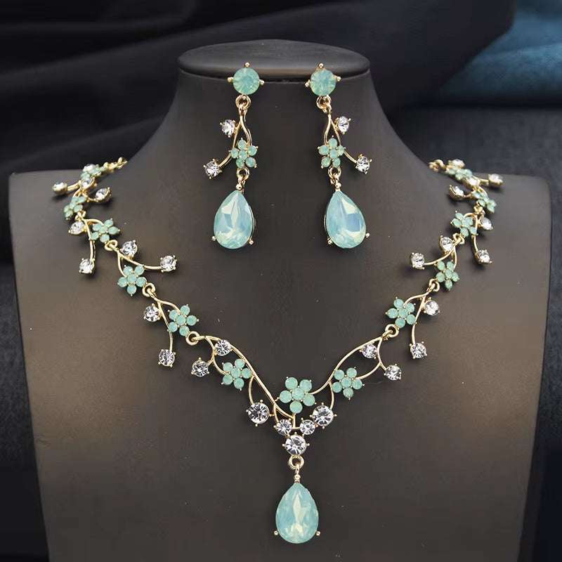 Rhinestone water drop necklace and earrings set with gold plated floral design and crystals