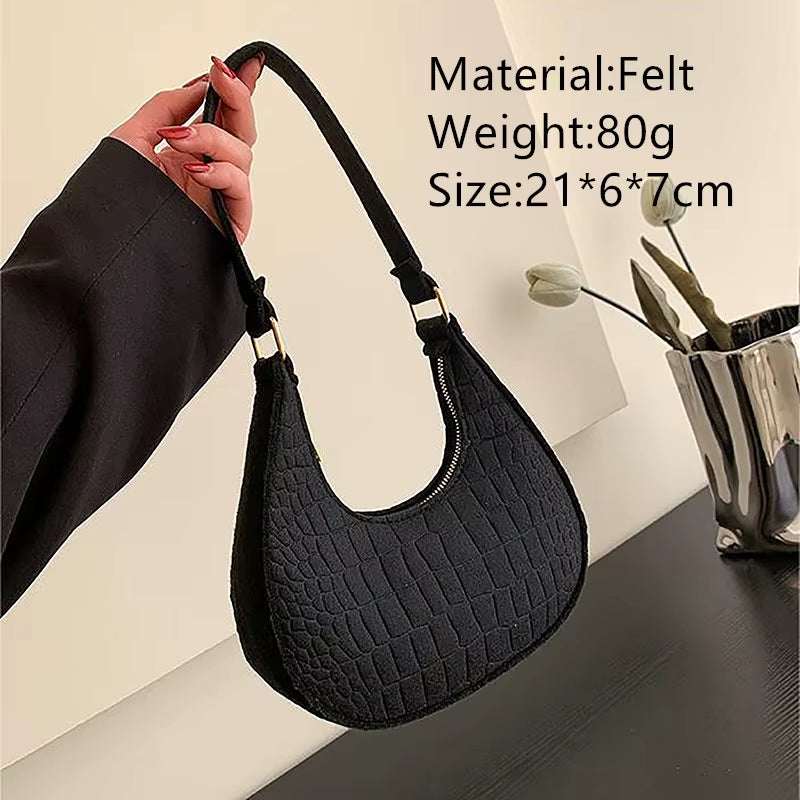 Black felt ball purse for teenagers with textured design and shoulder strap, lightweight and compact size.