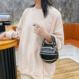 Black round basketball ball purse for teenagers with shoulder strap and handle