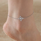 silver knot pendant anklet on ankle close-up stainless steel chain jewelry