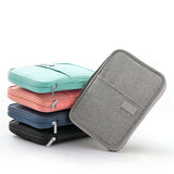 Waterproof passport holders in blue, pink, navy, black, and grey colors stacked with zipper closures
