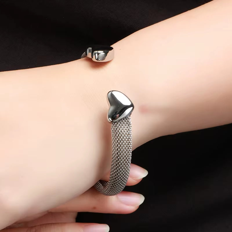Vintage stainless steel heart-shaped mesh bracelet on wrist