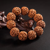 Fashion Rudraksha Beads Bracelet with natural brown textured beads on wooden stand