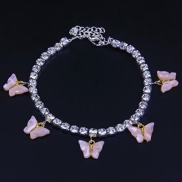 Silver anklet with pink butterfly charms and rhinestones on black background
