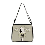 Cow print small shoulder bag with cartoon cow face design and adjustable strap