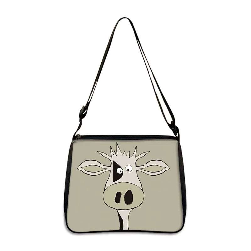 Cow print small shoulder bag with cartoon cow face design and adjustable strap